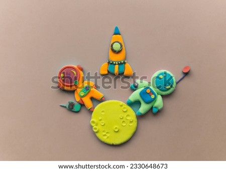 Astronauts On The Moon. Astronaut Is Made Out Of Play Clay. Spaceship, moon and two cute cosmonauts