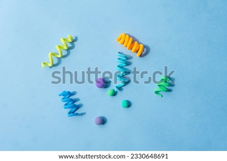 Colorful abstract figures made of plasticine, spirals and balls of different sizes. Funny illustration for the background of children's holidays, frame for text