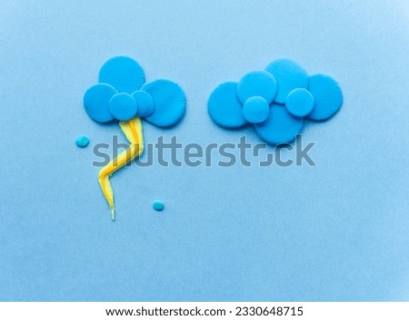 cloud with lightning from plasticine on blue background