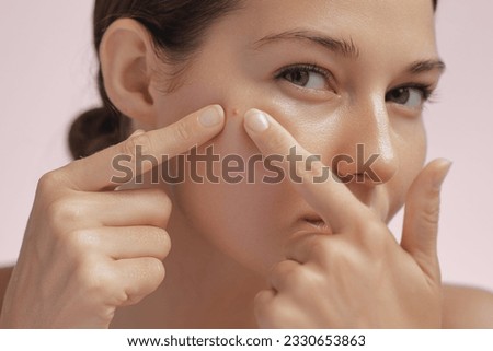 Skin problem. Depressed woman touching pimple on face looking at mirror. Facial skin issues, medical care, and treatment concept. Selective Focus. High-quality photo Royalty-Free Stock Photo #2330653863
