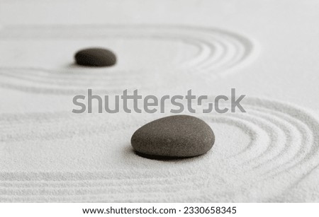 Zen Garden with Grey Stone on White Sand Line Texture Background, Top View Black Rock Sea Stone on Sand Wave Parallel Lines Pattern in Japanese stye, Simplicity Day, Meditation,Zen like concept