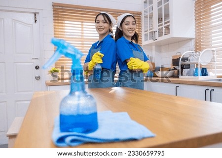 Close-up of the Portrait Two young professional housewives cleaning the house Royalty-Free Stock Photo #2330659795
