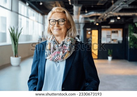 Portrait of smiling 50's stylish, confident mature businesswoman, middle aged company ceo director, experienced senior female professional, business coach team leader in modern office. Female leader Royalty-Free Stock Photo #2330673193