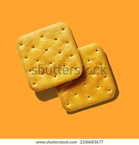 Two crackers close-up on orange background