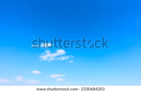 Beautiful almost clear blue sky with light clouds. Background with large space for text
