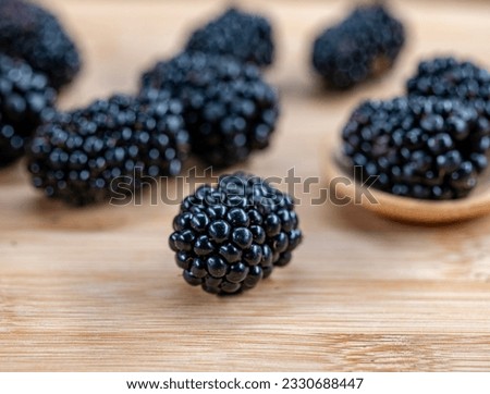 top view. Photo of blackberries in clay pot on wooden table. High resolution product.