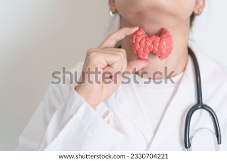 Doctor with human Thyroid anatomy model. Hyperthyroidism, Hypothyroidism, Hashimoto Thyroiditis, Thyroid Tumor and Cancer, Postpartum, Papillary Carcinoma and Health concept Royalty-Free Stock Photo #2330704221