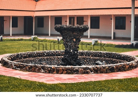 an image of a fountain with rocks