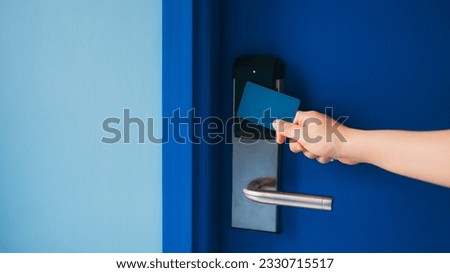Electronic card key for open door in hotel. Smart card key to lock and unlock door. Security systems and protection concept.	