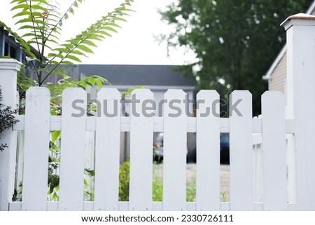 A pristine white fence stands as a symbol of purity, protection, and boundaries in a harmonious landscape, embodying the idea of privacy and serenity