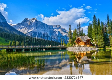 Bridge leading to wooden lodge on Emerald lake with beautiful reflections in the Canadian Rockies of Yoho National Park, British Columbia, Canada. Royalty-Free Stock Photo #2330726597