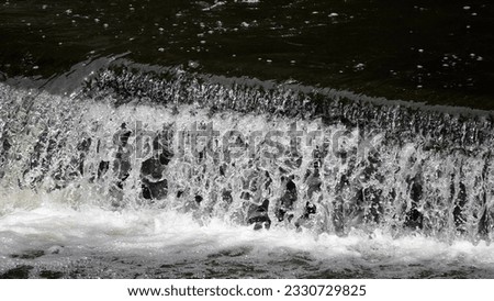                         Close up shots of the running water in the Cuyahoga River in Ohio.       