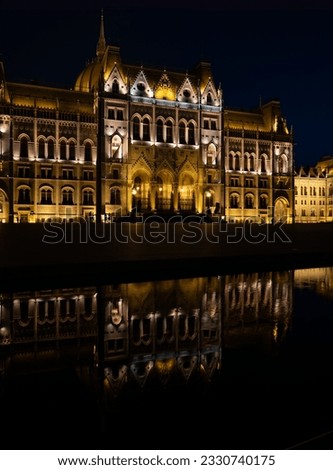 Night photograph of the hungary parliament facade and a reflection in a fountain. The photo is of the city of budapest and was taken at Kossuth square. Royalty-Free Stock Photo #2330740175