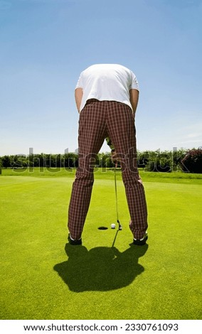 Golf club- golfer concentrating on the 18th hole