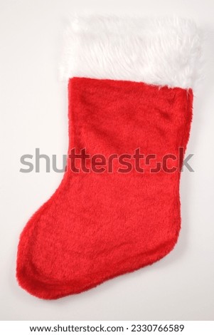 Still life of furry red Christmas stocking.