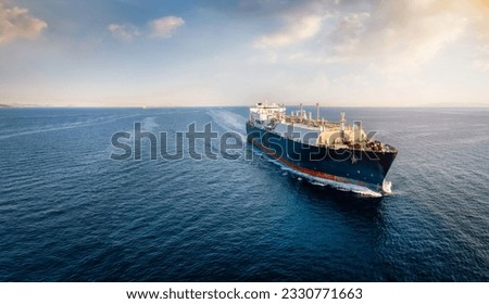 Front view of a big LNG tanker ship traveling with full speed over the ocean during sunset with copy space Royalty-Free Stock Photo #2330771663