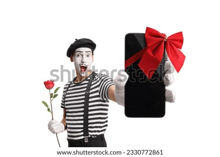 Mime holding a red rose and showing a smartphone with a red bow isolated on white background