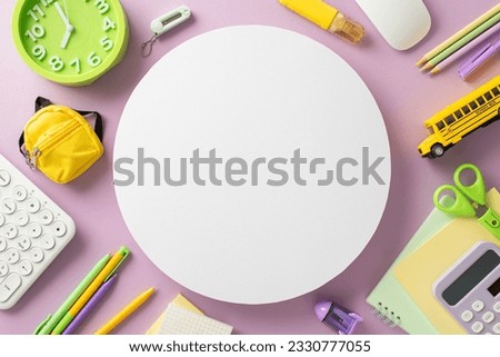 Explore the world of distant learning through this creative above view picture showcasing notepads, keyboard and school supplies on an isolated light purple backdrop. Perfect for text or advertising