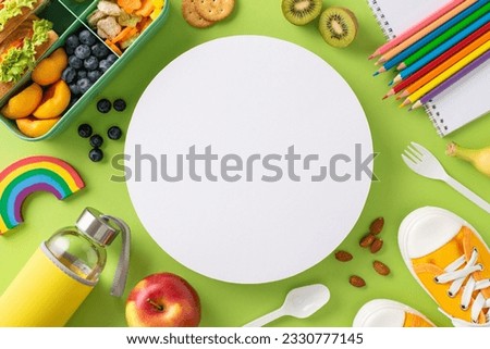 Paint picture of lunchtime bliss with an above view shot of lunchbox packed with sandwiches, fruits, veggies and bottle on green isolated background, empty circle for text or promotional content