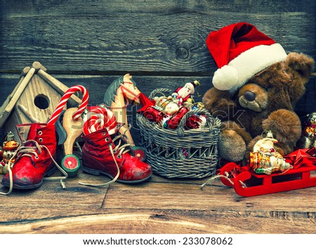 nostalgic christmas decoration with antique toys over wooden background. vintage style toned picture
