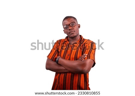 Portrait of a young thoughtful African boy with his arms folded and eyeglasses