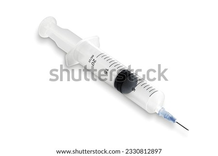 Medical syringe on a white surface with shadow
