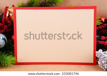 Handmade Christmas card with Christmas decorations on wooden background