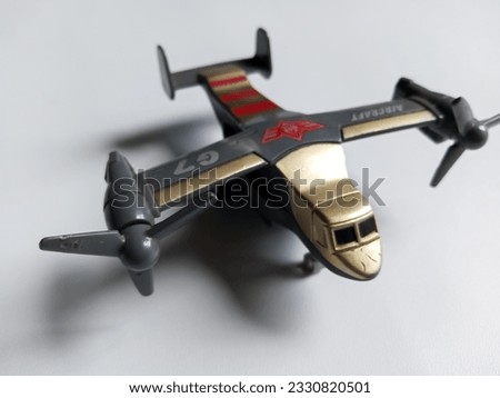 child toy in the form of an airplane with 2 left and right gray propellers on an isolated white background and copy space