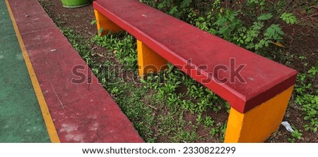 rough texture of a basketball court with red, green and yellow stripe colors