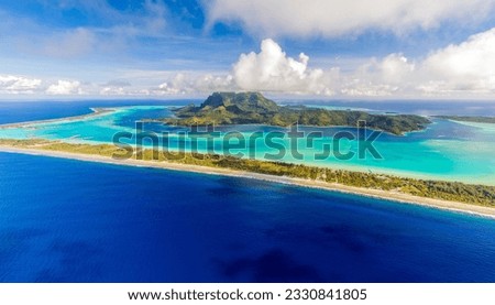 Aerial view of Bora Bora, French Polynesia, its famous lagoon, Mount Otemanu, and the surrounding motus (islets)