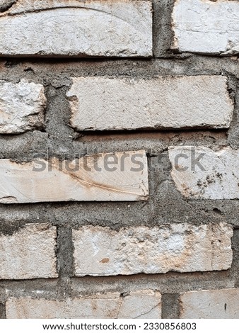 wall background composed of white bricks and cement mortar