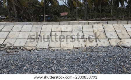 the wave barrier how to resist waves and beach abrasion. wave barrier concrete in the form of a beach box Royalty-Free Stock Photo #2330858791