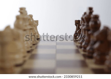 Chess game black and white face to face with blur foreground
