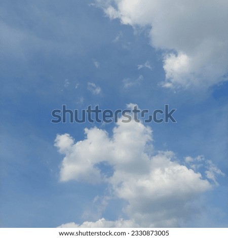 White Clouds in a Blue Sky in Summer - stock photo