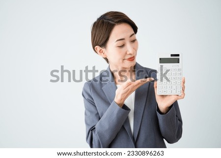 Business image of a young woman who guides with a calculator