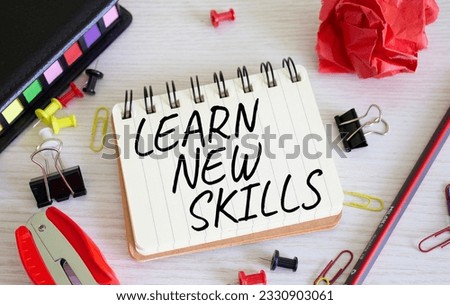 Learn new skills symbol. Concept words Learn new skills on white notebook. Beautiful wooden background. Business and Learn new skills concept. Copy space.