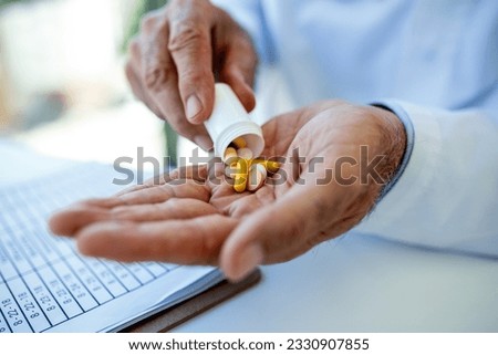 Hand of doctors holding many different pills. Photo of doctor prescribes pills and antibiotics. Medicine and treatment concept background. Royalty-Free Stock Photo #2330907855