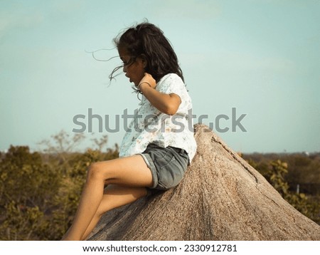 Awesome photo present filter effect on portrait sunset cute little girl image. Natural blur background and clear focus.Dark mode of adventure scenery. Different close up hand style wearing black. 