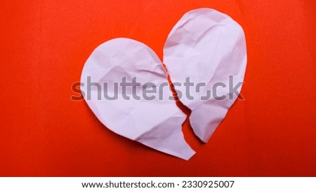 broken heart shaped pink paper on red background Royalty-Free Stock Photo #2330925007