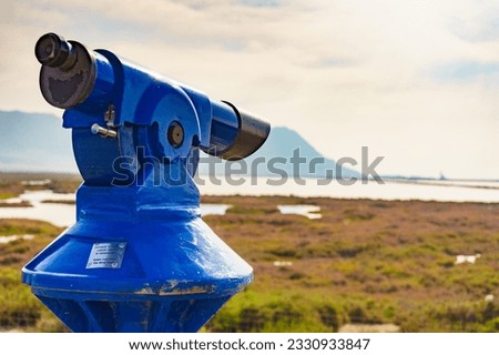 Tourism vacation and travel. Sightseeing binoculars tourist telescope, overlooking Las Salinas landscape, Cabo de Gata Nijar Natural Park, Andalusia Spain. Royalty-Free Stock Photo #2330933847