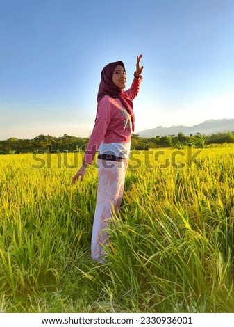 Portrait of beautiful lady playing and walking at ricefield during summer holiday