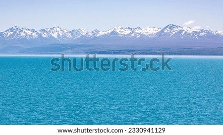 The mountain view of  alpine as snow-capped mount peaks and blue lake in Winter mountains, panorama scene