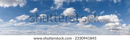 Panoramic view of cloudy sky with ruffled fair weather and cluster clouds against blue sky in sunny weather