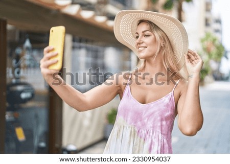 Young blonde woman tourist smiling confident make selfie by smartphone at coffee shop terrace