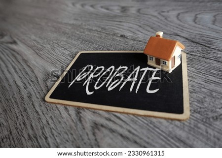 Toy house and chalkboard with text PROBATE. Property and law concept Royalty-Free Stock Photo #2330961315