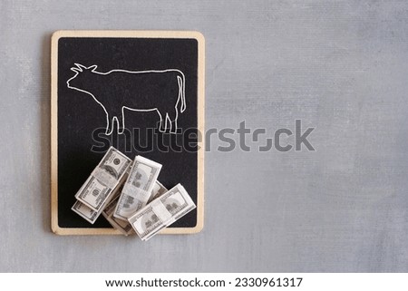 Drawing of cow and money with copy space. Business finance, cash cow concept.