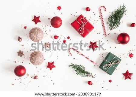 Christmas composition. Christmas gifts, red and golden decorations on white background. Flat lay, top view Royalty-Free Stock Photo #2330981179