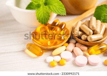 Alternative medicine herbal organic capsule with vitamin E omega 3 fish oil, mineral, drug with herbs leaf natural supplements for healthy good life. Royalty-Free Stock Photo #2330992171