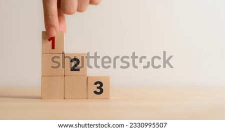 Task priority and management concept. The order of priority in any activity. Set work priority, arrange to do list. Wooden cube blocks with number first, second and third. Royalty-Free Stock Photo #2330995507