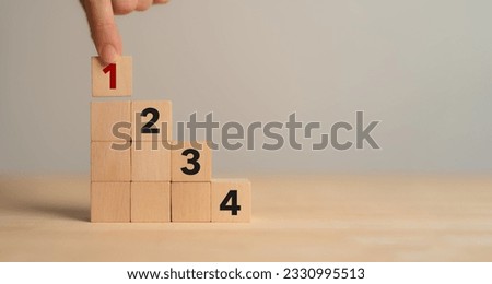 Task priority and management concept. The order of priority in any activity. Set work priority, arrange to do list. Wooden cube blocks with number first, second, third and fourth. Royalty-Free Stock Photo #2330995513